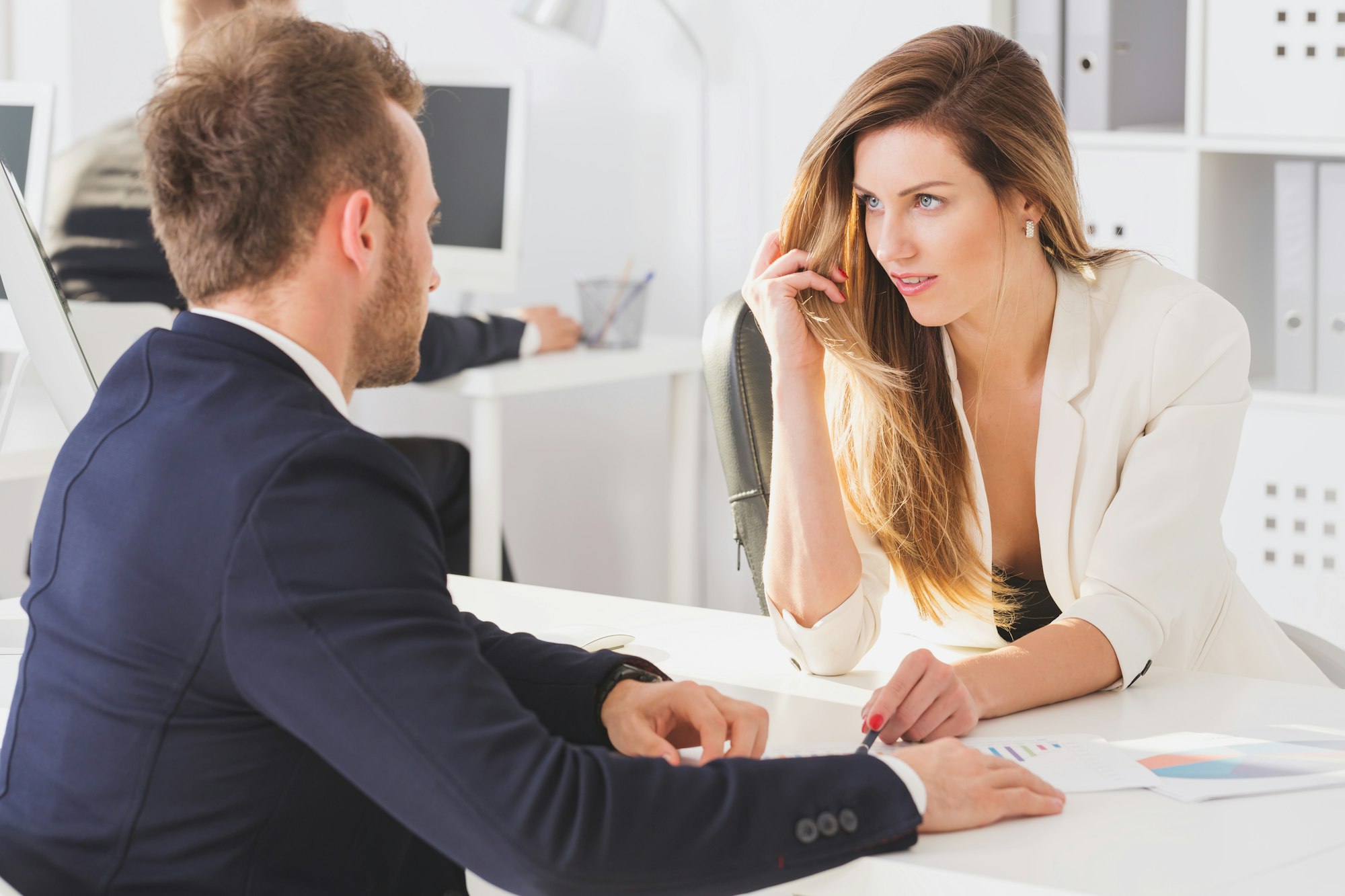 Businesswoman looking seductively at colleague