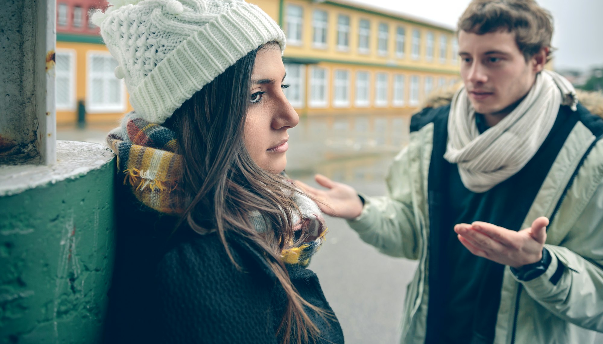 Displeased woman listening arguments of man in quarrel