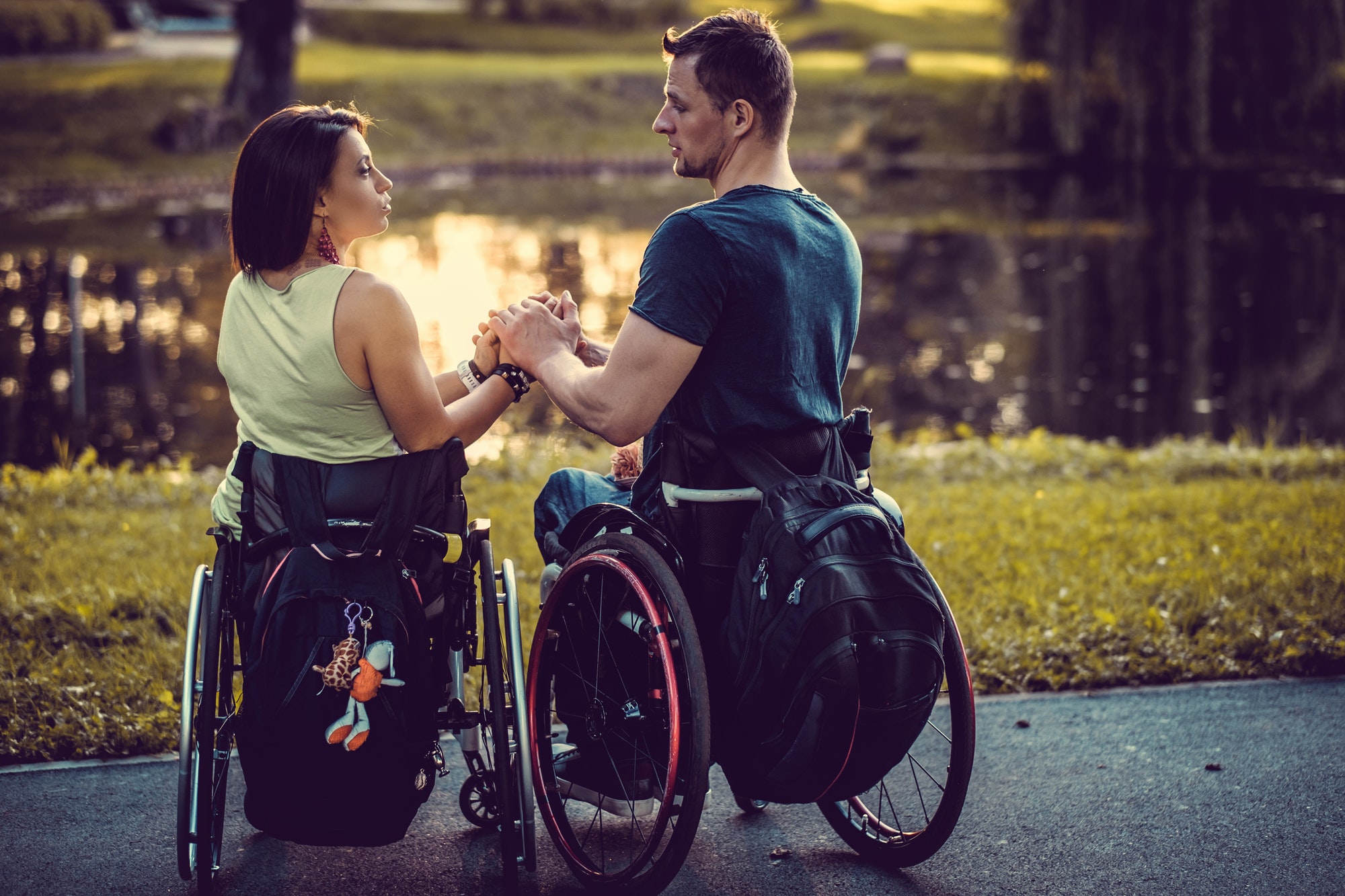 Handicapped young couple resting in a park.