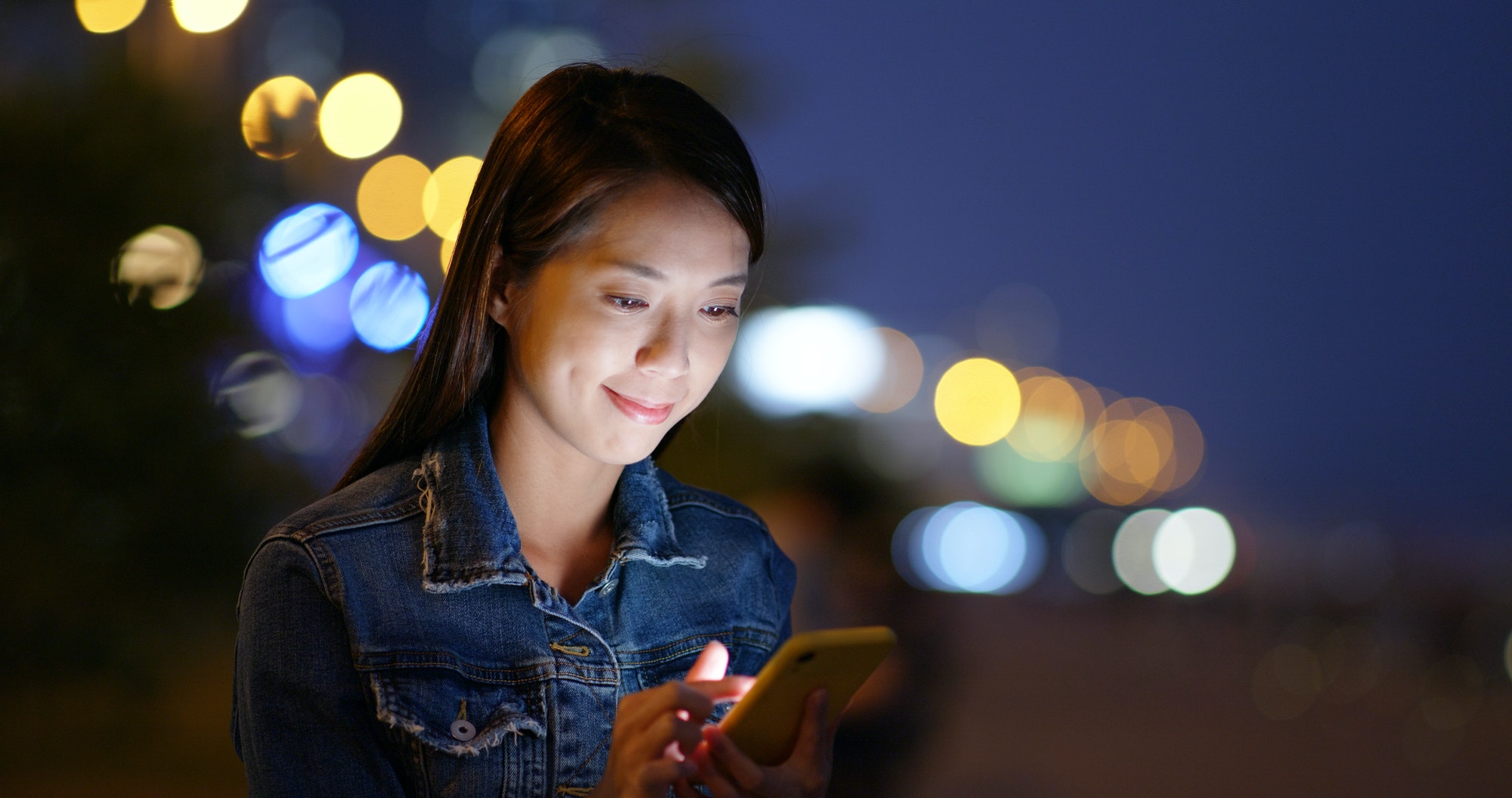 Woman look at mobile phone at night