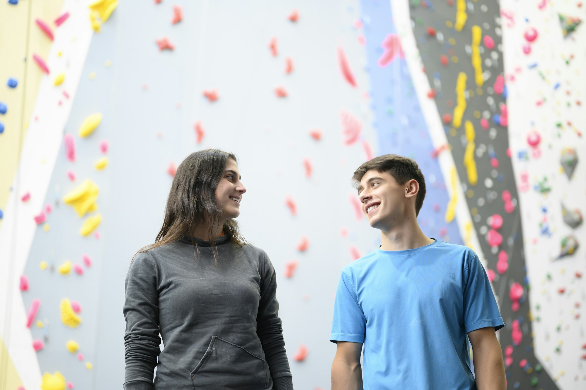 Funny couple laughing with a smile on the climbing wall
