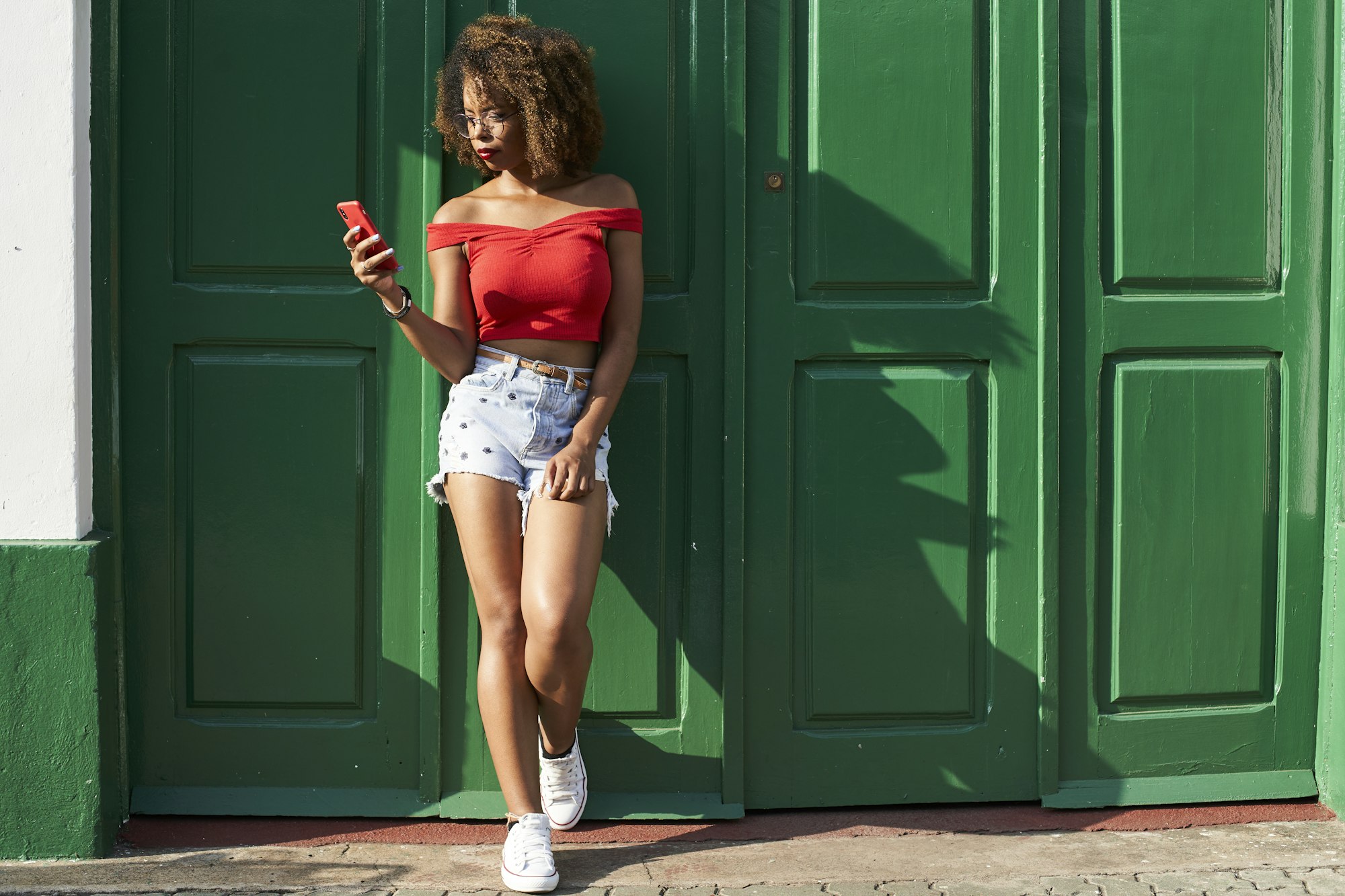 Woman in red checking her phone