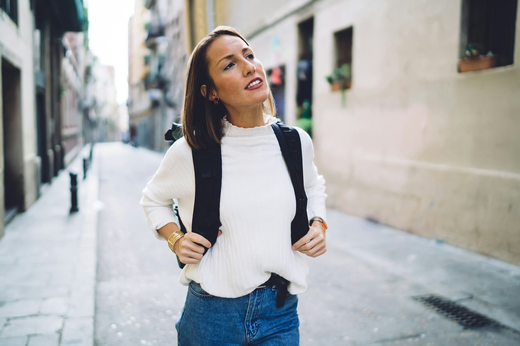 Confident traveling woman exploring old city