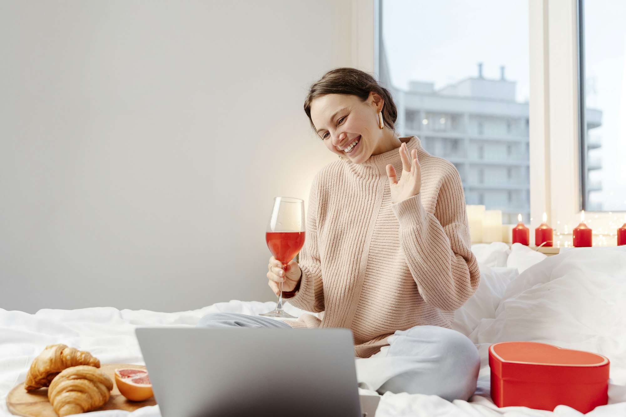 Woman using laptop drinking wine communication with boyfriend. Valentines day. Online dating